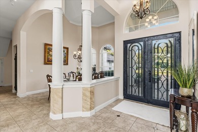 Life unfolds beautifully in this golf front estate in the on The Legacy Club At Alaqua Lakes in Florida - for sale on GolfHomes.com, golf home, golf lot