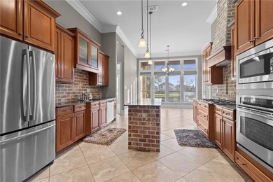 Enjoy serene water and golf course views from this exceptional on Oak Harbor Golf Club in Louisiana - for sale on GolfHomes.com, golf home, golf lot