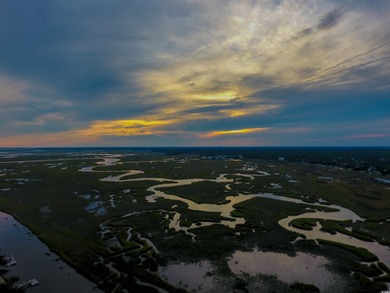 Enjoy breathtaking panoramic views of the marsh, estuary, and on DeBordieu Country Club in South Carolina - for sale on GolfHomes.com, golf home, golf lot