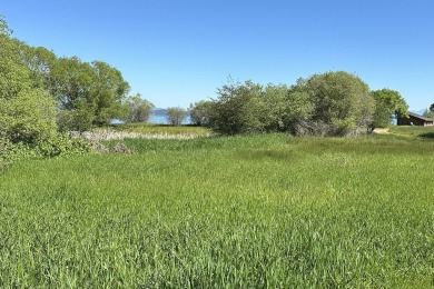 Enjoy breathtaking views of Flathead Lake and the iconic Mission on Polson Bay Golf Course - Championship Course in Montana - for sale on GolfHomes.com, golf home, golf lot