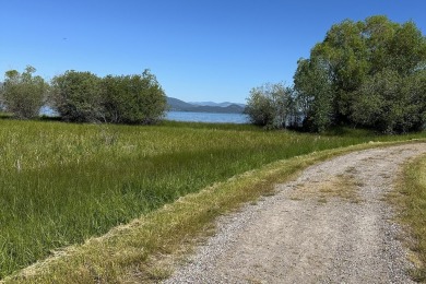 Enjoy breathtaking views of Flathead Lake and the iconic Mission on Polson Bay Golf Course - Championship Course in Montana - for sale on GolfHomes.com, golf home, golf lot