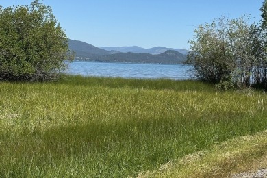 Enjoy breathtaking views of Flathead Lake and the iconic Mission on Polson Bay Golf Course - Championship Course in Montana - for sale on GolfHomes.com, golf home, golf lot