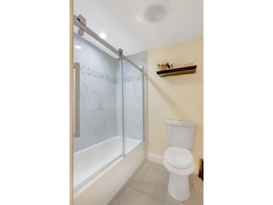 Experience breathtaking lakefront living in this stunning on Boca Lago Golf and Country Club in Florida - for sale on GolfHomes.com, golf home, golf lot