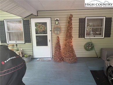 Welcome to 61 River Loop, a charming mountain retreat nestled on Land Harbor Golf Course in North Carolina - for sale on GolfHomes.com, golf home, golf lot