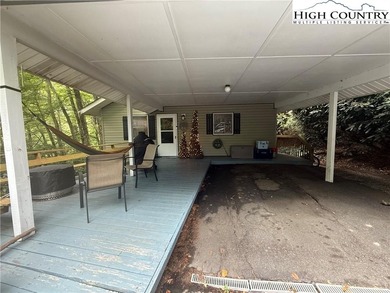 Welcome to 61 River Loop, a charming mountain retreat nestled on Land Harbor Golf Course in North Carolina - for sale on GolfHomes.com, golf home, golf lot