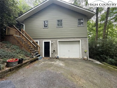 Welcome to 61 River Loop, a charming mountain retreat nestled on Land Harbor Golf Course in North Carolina - for sale on GolfHomes.com, golf home, golf lot