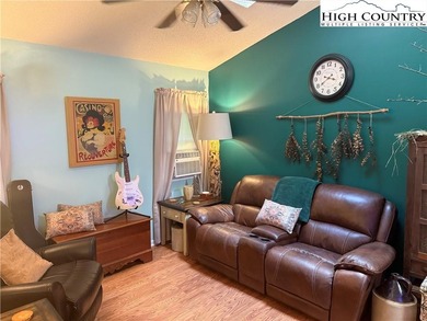 Welcome to 61 River Loop, a charming mountain retreat nestled on Land Harbor Golf Course in North Carolina - for sale on GolfHomes.com, golf home, golf lot