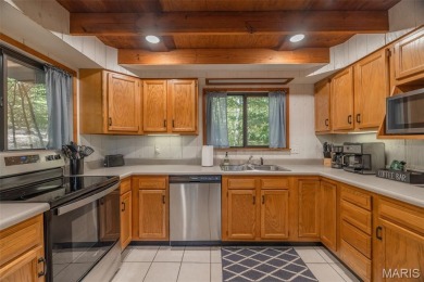 Escape to your own lakeside paradise at this super cute chalet on Innsbrook Resort Golf Course in Missouri - for sale on GolfHomes.com, golf home, golf lot
