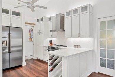 Walk through the front gate and courtyard to discover refined on The Meadows Golf and Country Club in Florida - for sale on GolfHomes.com, golf home, golf lot