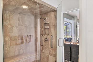 Walk through the front gate and courtyard to discover refined on The Meadows Golf and Country Club in Florida - for sale on GolfHomes.com, golf home, golf lot