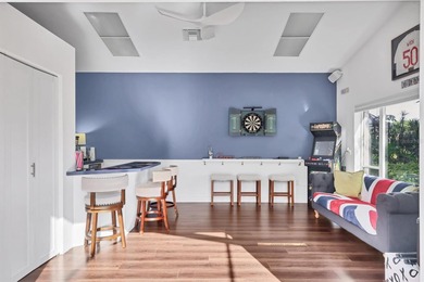 Walk through the front gate and courtyard to discover refined on The Meadows Golf and Country Club in Florida - for sale on GolfHomes.com, golf home, golf lot