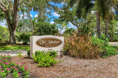 Walk through the front gate and courtyard to discover refined on The Meadows Golf and Country Club in Florida - for sale on GolfHomes.com, golf home, golf lot