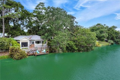 This South-end bungalow offers beautiful views of Lake Worth in on Sea Island Golf Club in Georgia - for sale on GolfHomes.com, golf home, golf lot