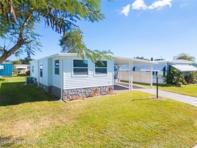 Welcome to your dream home in serene Barefoot Bay, FL! This on Barefoot Bay Golf Course in Florida - for sale on GolfHomes.com, golf home, golf lot