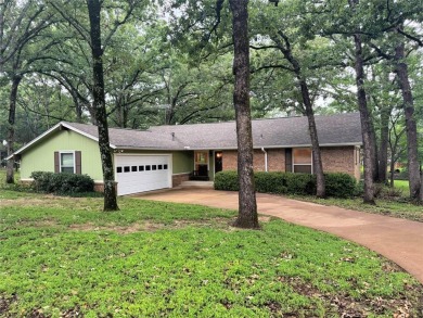 This charming water front home sits on a spacious tract under a on Star Harbor Golf Club in Texas - for sale on GolfHomes.com, golf home, golf lot