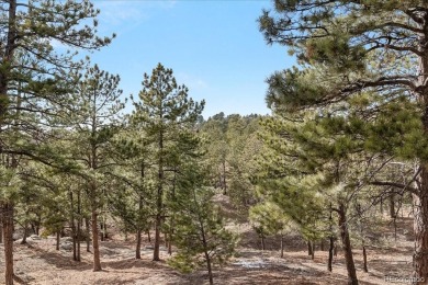 Exquisitely located on the edge of 11 acres of HOA owned forest on The Ridge At Castle Pines North in Colorado - for sale on GolfHomes.com, golf home, golf lot