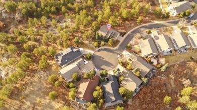 Exquisitely located on the edge of 11 acres of HOA owned forest on The Ridge At Castle Pines North in Colorado - for sale on GolfHomes.com, golf home, golf lot