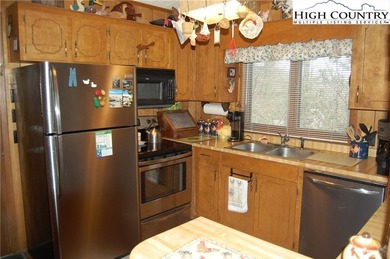 Nestled in the rhododendrons, you'll find this 2bdr/2bath on Land Harbor Golf Course in North Carolina - for sale on GolfHomes.com, golf home, golf lot