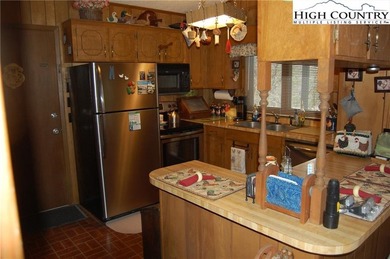 Nestled in the rhododendrons, you'll find this 2bdr/2bath on Land Harbor Golf Course in North Carolina - for sale on GolfHomes.com, golf home, golf lot