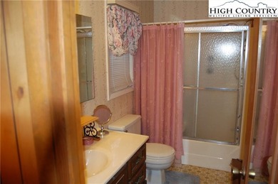 Nestled in the rhododendrons, you'll find this 2bdr/2bath on Land Harbor Golf Course in North Carolina - for sale on GolfHomes.com, golf home, golf lot