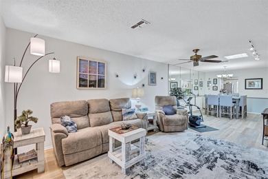 This end unit villa is right next to the covered carport and on Highland Lakes Executive Golf Course in Florida - for sale on GolfHomes.com, golf home, golf lot