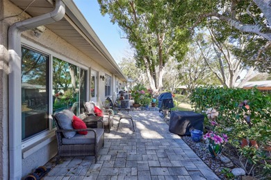 This end unit villa is right next to the covered carport and on Highland Lakes Executive Golf Course in Florida - for sale on GolfHomes.com, golf home, golf lot