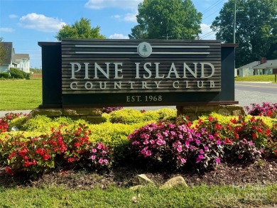 Welcome to this extraordinary all-brick estate, perfectly on Pine Island Country Club in North Carolina - for sale on GolfHomes.com, golf home, golf lot