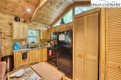 One bedroom, one bath Green River Log Cabin located in the on Land Harbor Golf Course in North Carolina - for sale on GolfHomes.com, golf home, golf lot