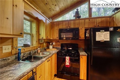 One bedroom, one bath Green River Log Cabin located in the on Land Harbor Golf Course in North Carolina - for sale on GolfHomes.com, golf home, golf lot