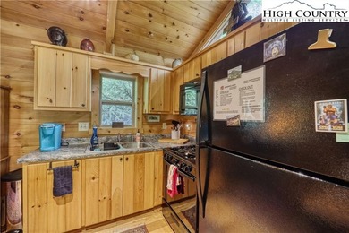 One bedroom, one bath Green River Log Cabin located in the on Land Harbor Golf Course in North Carolina - for sale on GolfHomes.com, golf home, golf lot