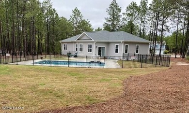 Enjoy the best of lake and golf community living in this on Seven Lakes Country Club in North Carolina - for sale on GolfHomes.com, golf home, golf lot