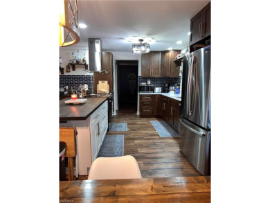 Welcome to your dream home at 6765 Overlook Drive, nestled in on Cypress Lake Country Club in Florida - for sale on GolfHomes.com, golf home, golf lot