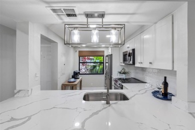 LUXURY WATERFRONT LIVING--DESIGNER FINISHES, POOL, SUNSET AND on Isla Del Sol Yacht and Country Club in Florida - for sale on GolfHomes.com, golf home, golf lot