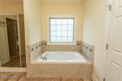 Proudly presenting this low-maintenance brick home located on on Ocean Ridge Plantation in North Carolina - for sale on GolfHomes.com, golf home, golf lot
