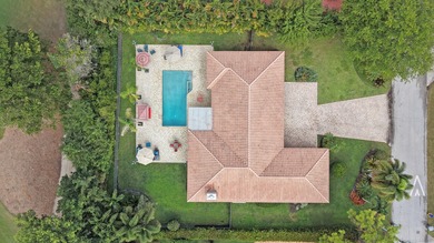 Situated on a nearly half-acre, fully fenced lot in a quiet on Pine Tree Golf Club in Florida - for sale on GolfHomes.com, golf home, golf lot