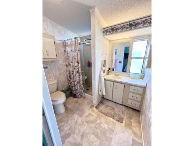 This charming two-bedroom, two-bathroom home is situated on a on Pine Lakes Country Club in Florida - for sale on GolfHomes.com, golf home, golf lot