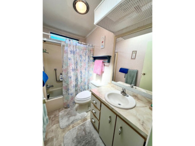 This charming two-bedroom, two-bathroom home is situated on a on Pine Lakes Country Club in Florida - for sale on GolfHomes.com, golf home, golf lot