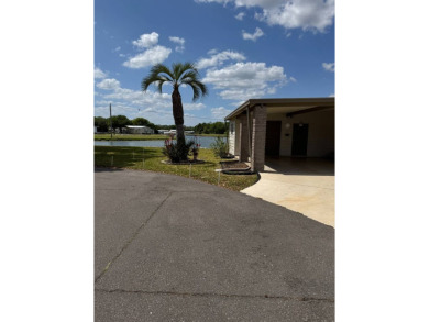 This stunning 2-bedroom, 2-bathroom home, including golf cart on Golden Lakes Golf Course in Florida - for sale on GolfHomes.com, golf home, golf lot