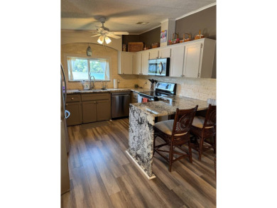 This stunning 2-bedroom, 2-bathroom home, including golf cart on Golden Lakes Golf Course in Florida - for sale on GolfHomes.com, golf home, golf lot