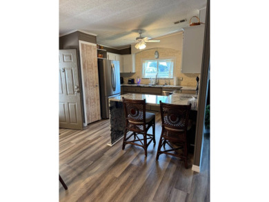This stunning 2-bedroom, 2-bathroom home, including golf cart on Golden Lakes Golf Course in Florida - for sale on GolfHomes.com, golf home, golf lot