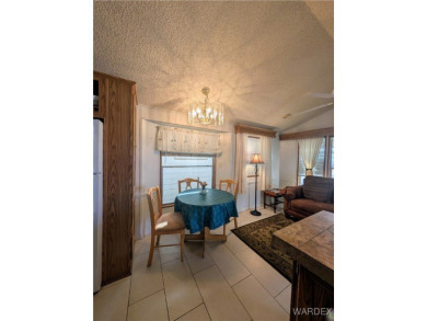 Perfect snowbird retreat. The enclosed patio offers extra room on Riverview Golf Course in Arizona - for sale on GolfHomes.com, golf home, golf lot