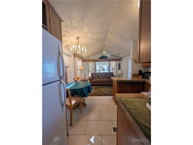 Perfect snowbird retreat. The enclosed patio offers extra room on Riverview Golf Course in Arizona - for sale on GolfHomes.com, golf home, golf lot