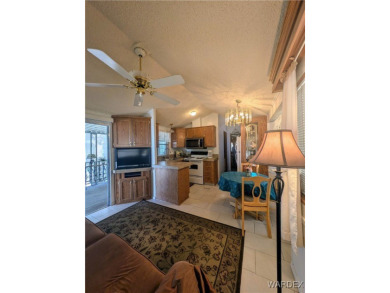 Perfect snowbird retreat. The enclosed patio offers extra room on Riverview Golf Course in Arizona - for sale on GolfHomes.com, golf home, golf lot