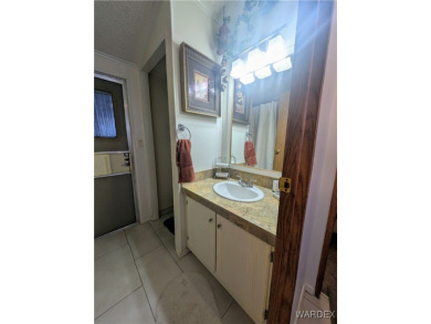 Perfect snowbird retreat. The enclosed patio offers extra room on Riverview Golf Course in Arizona - for sale on GolfHomes.com, golf home, golf lot