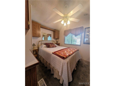 Perfect snowbird retreat. The enclosed patio offers extra room on Riverview Golf Course in Arizona - for sale on GolfHomes.com, golf home, golf lot