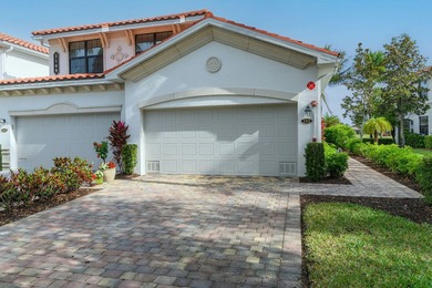 Enjoy a first-floor end-unit coach home with beautiful lake on The Rookery At Marco in Florida - for sale on GolfHomes.com, golf home, golf lot