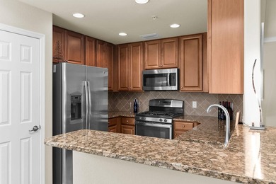 Enjoy a first-floor end-unit coach home with beautiful lake on The Rookery At Marco in Florida - for sale on GolfHomes.com, golf home, golf lot