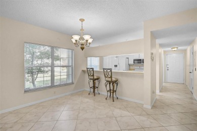 Ground Floor End-Unit Condo in Fairway Trace at Peridia Golf & on Peridia Golf and Country Club in Florida - for sale on GolfHomes.com, golf home, golf lot