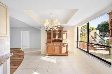 Serene golf course and pond views enhance this first-floor on Quail Ridge Golf Course and Country Club in Florida - for sale on GolfHomes.com, golf home, golf lot