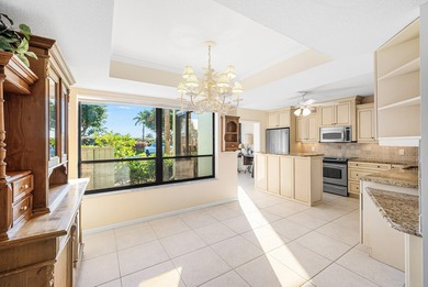 Serene golf course and pond views enhance this first-floor on Quail Ridge Golf Course and Country Club in Florida - for sale on GolfHomes.com, golf home, golf lot